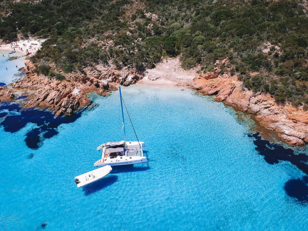 Catamaran anchored in the crystal-clear waters of Isola Maddalena